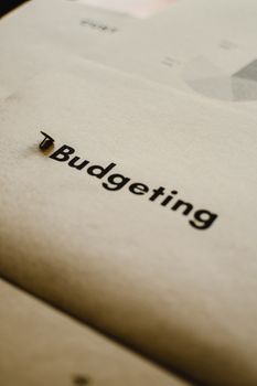 Close-up of budgeting concept on paper with focus on typography and abstract elements.